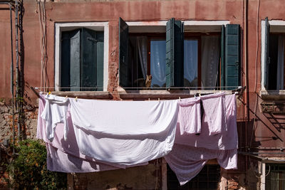 Clothes drying on window of building