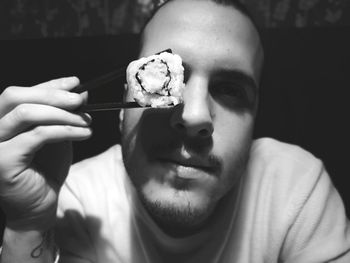 Close-up portrait of man holding ice cream