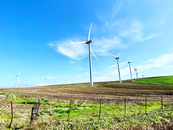 Windmill on field against sky