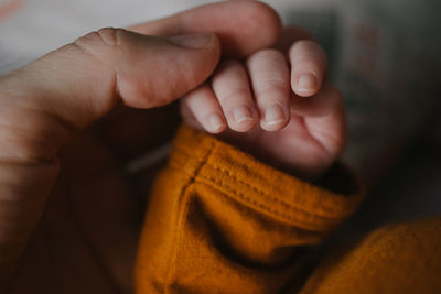 Hand of a mother holding baby's hand. close-up.