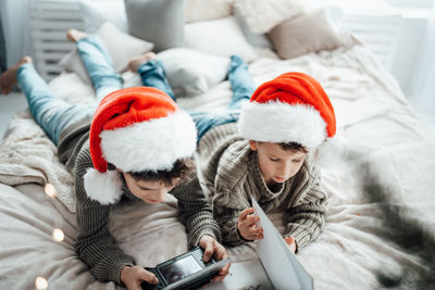 Rear view of mother and daughter in bedroom during winter