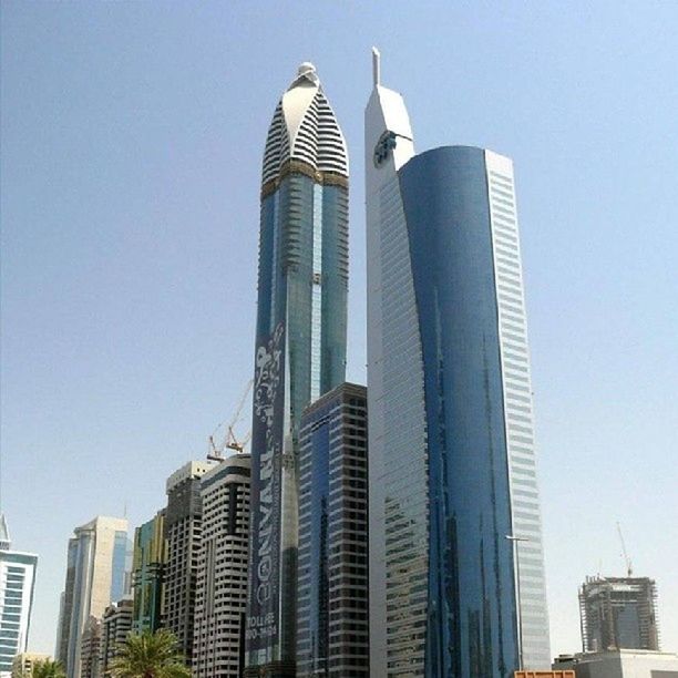 architecture, building exterior, built structure, low angle view, skyscraper, tall - high, tower, clear sky, modern, city, office building, tall, travel destinations, capital cities, development, famous place, building, financial district, international landmark, urban skyline