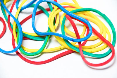 Close-up of colorful cables over white background