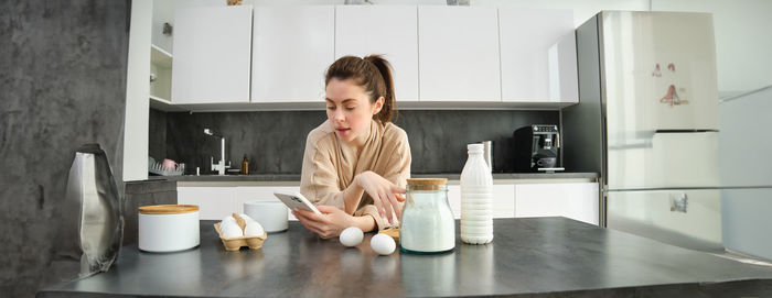 Portrait of young woman sitting at home