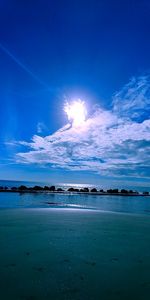 Scenic view of sea against blue sky