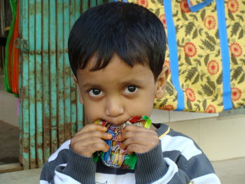 Close-up of boy holding packet