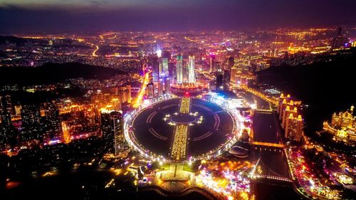 High angle view of illuminated modern buildings in city at night