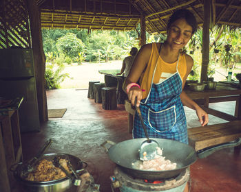 Smiling woman preparing food 