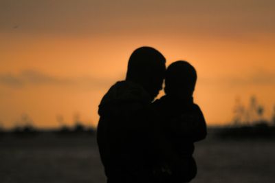 Silhouette of woman at sunset