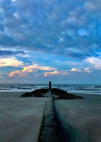 Scenic view of beach against sky during sunset
