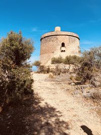 Old ruin building against blue sky