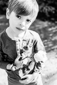 Portrait of cute boy holding baby