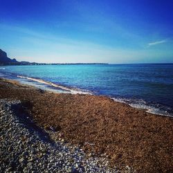 Scenic view of sea against clear blue sky