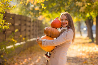 Portrait of smiling young woman exercising in park