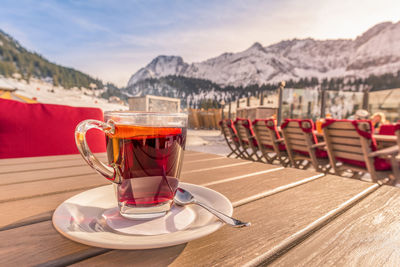 Close-up of black tea on table against mountain