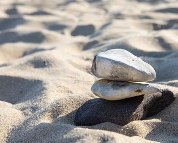 Close-up of pebbles on sand at beach