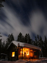 Illuminated building against sky at night