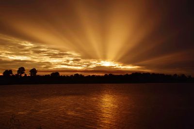 Scenic view of lake against romantic sky at sunset