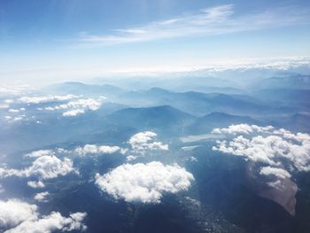 Aerial view of mountains against blue sky