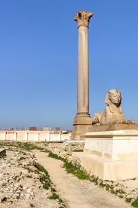 Statue of historic building against blue sky