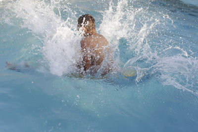 Man swimming in pool