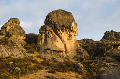 Low angle view of rock formations against sky