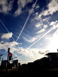 Low angle view of silhouette buildings against sky