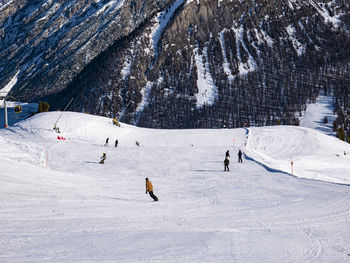 People skiing on snow covered mountain