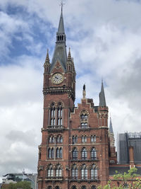 Low angle view of clock tower against sky