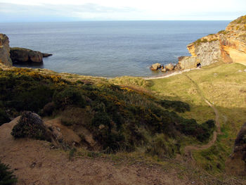 Scenic view of sea against cloudy sky