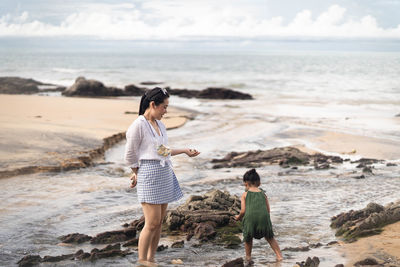 Full length of woman standing on beach