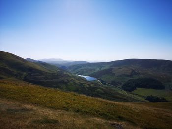 Scenic view of mountains against clear blue sky