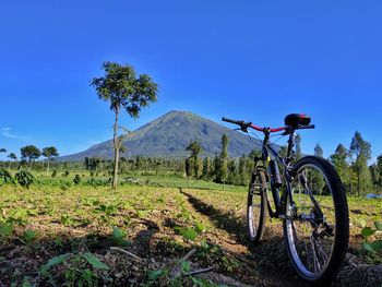 Bicycle on field against sky