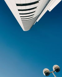 Low angle view of modern building against clear blue sky