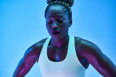 Portrait of woman against blue background