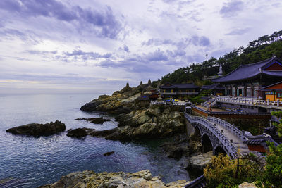 Panoramic view of sea and buildings against sky