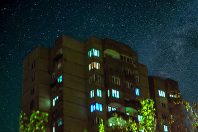 Low angle view of illuminated building against sky at night