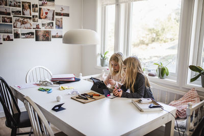 Sisters using digital tablet