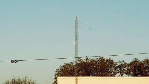 Low angle view of power lines against clear sky