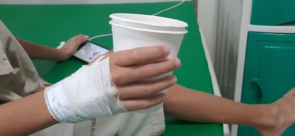 Midsection of woman holding drink