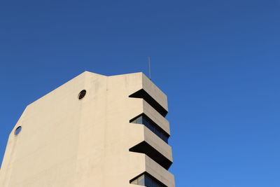 Low angle view of building against clear blue sky