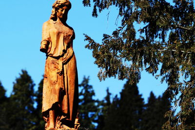 Low angle view of statue against sky