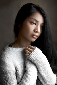 Portrait of a beautiful young woman in white sweater