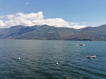 Scenic view of sea and mountains against sky