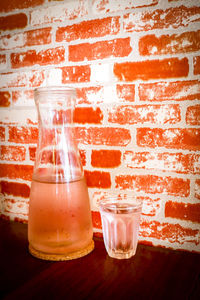 Close-up of drink on table against wall