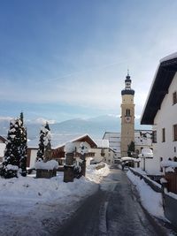 Buildings in city against sky during winter