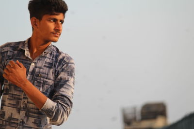 Side view of young man looking away