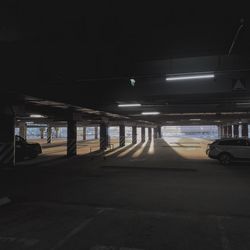 Cars parked in parking lot at night