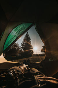 Low section of man in tent at sunset