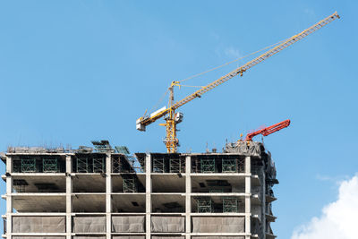 Low angle view of incomplete building against sky